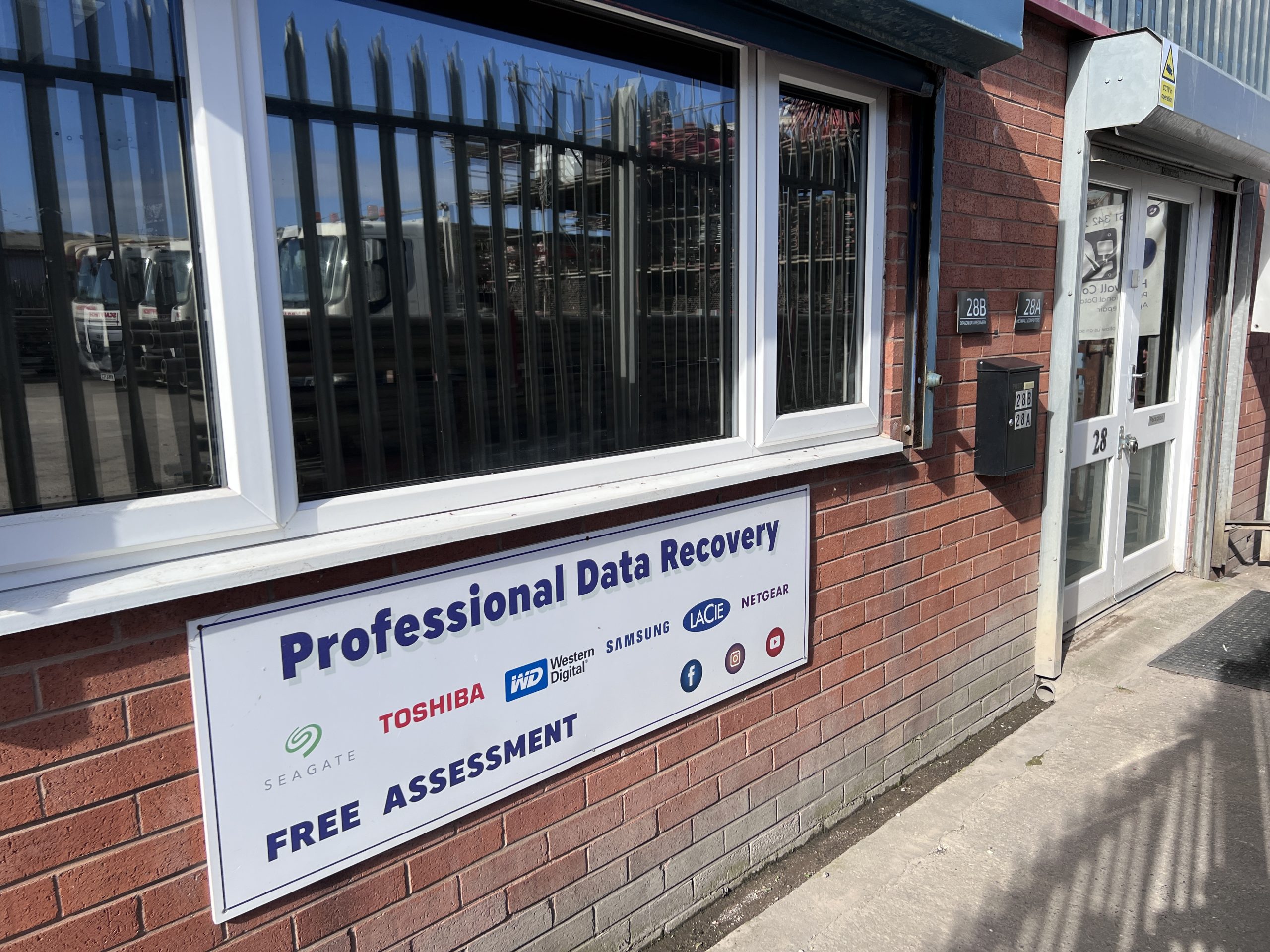 Entrance to Dragon Entrance to Dragon Data Recovery at 28b Tarran Way West, Moreton, Wirral — signage and unit plaque at the lab door